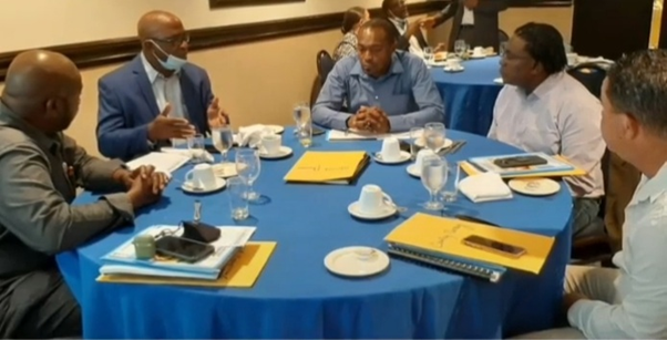 A group of people sitting around a table

Description automatically generated with medium confidence